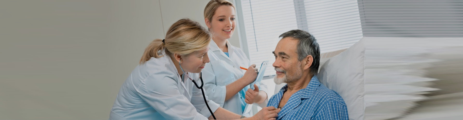 healthcare workers checking senior patient